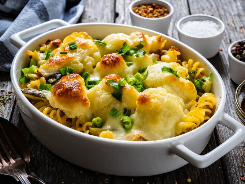 Baking dish with cauliflower pasta bake on a table
