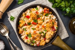 A chicken and rice skillet with vegetables.