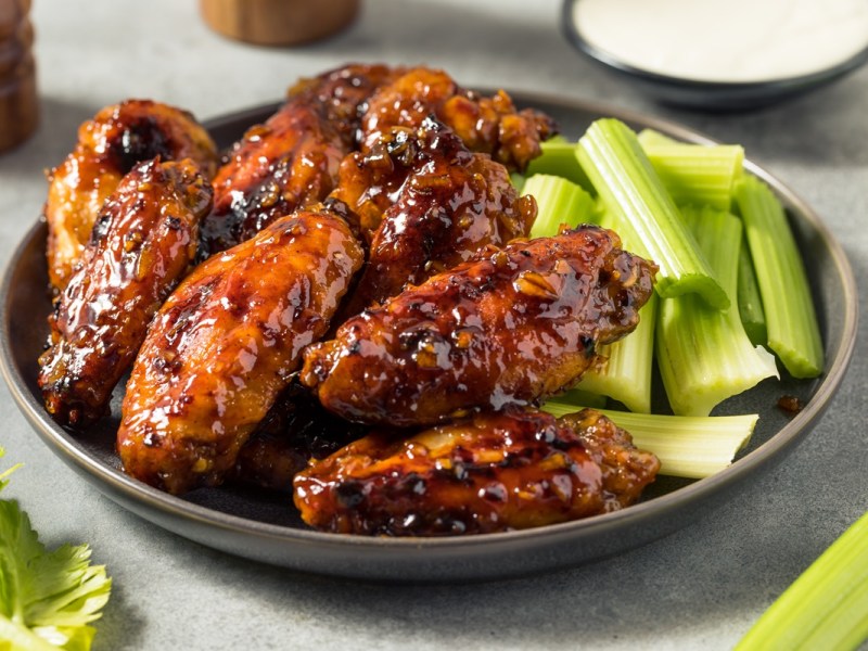 Honey Garlic Chicken with celery sticks on a plate.